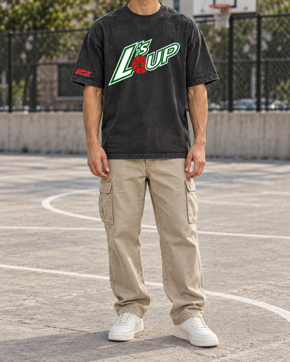 Man on an outdoor basketball court wearing the L's Up Comfort Colors tee in Black with khaki cargo pants and white sneakers