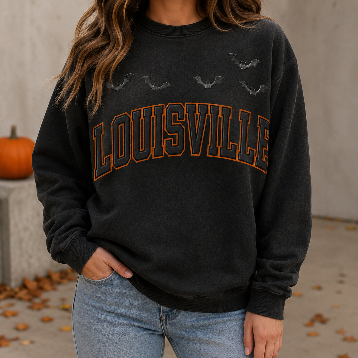 Louisville Halloween blackout crewneck in Black — worn on model outdoors beside a pumpkin