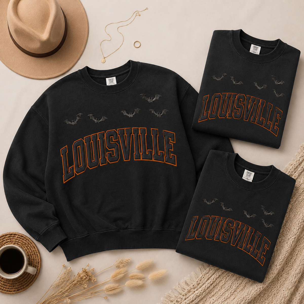 Louisville Halloween blackout crewnecks in Black — three-sweatshirt flat lay with felt hat, necklace and coffee